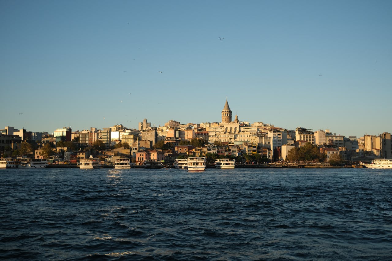 Scenic Istanbul skyline with Galata Tower viewed from the waterfront during sunset.